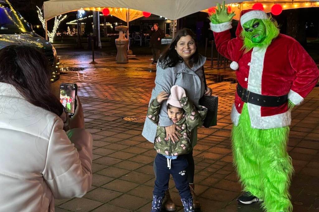 The Grinch reluctantly poses for a snap in Langford&rsquo;s Veterans Memorial Park. (Ben Fenlon/Goldstream Gazette)