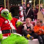 The Grinch rides the carousel in Langford&rsquo;s Veterans Memorial Park with James and Miguel Woodburn. (Ben Fenlon/Goldstream Gazette)