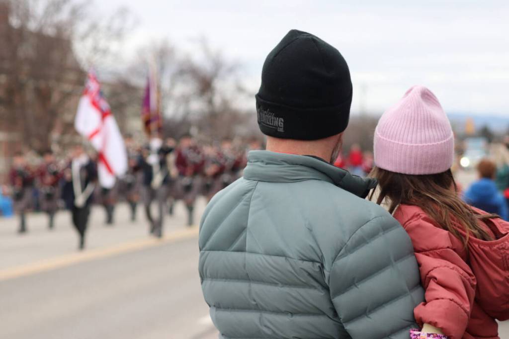 A girl being held up to watch the parade go by. There were thousands of spectators at this year&rsquo;s parade. (Brendan Shykora/Morning Star)