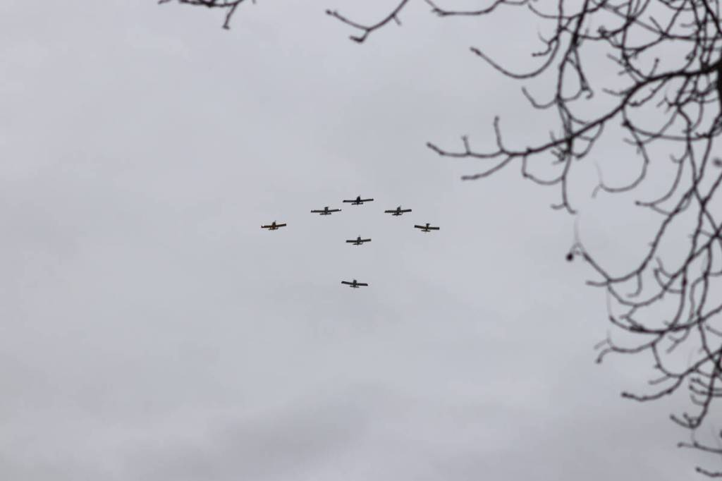 People looked to the skies as a flyover was done right over the parade route. (Brendan Shykora/Morning Star)